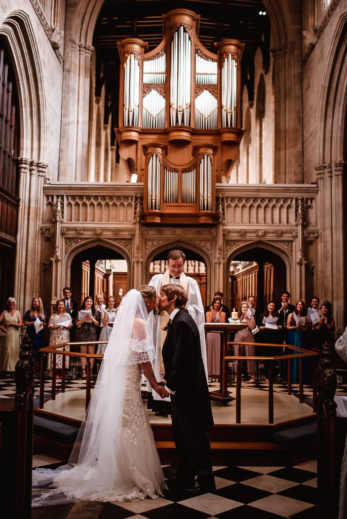 Bride and groom kissing during the ceremony