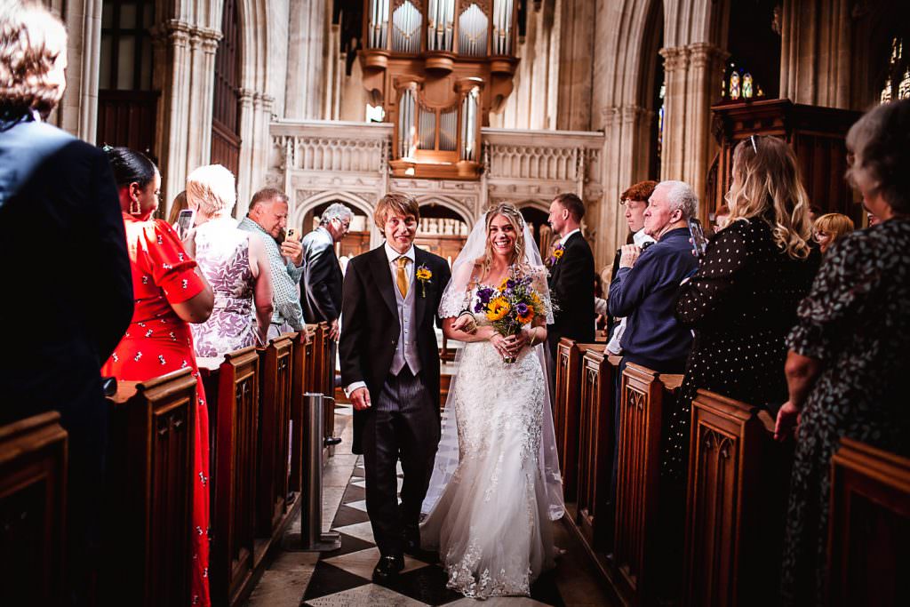 bride and groom walking down the isle at church in Oxford