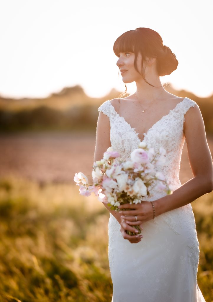 Sunset wedding photos bride and groom walking together during