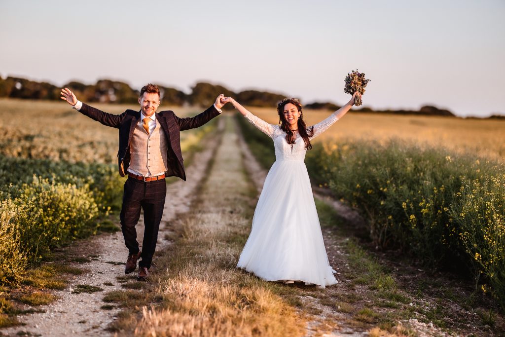 summer sunset photos of bride and groom wedding couple in the field