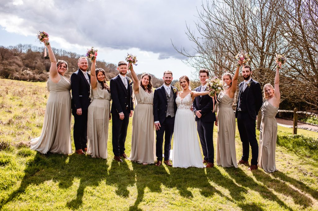 wedding party in the field. Groom and brides with their groomsmen and bridesmaids