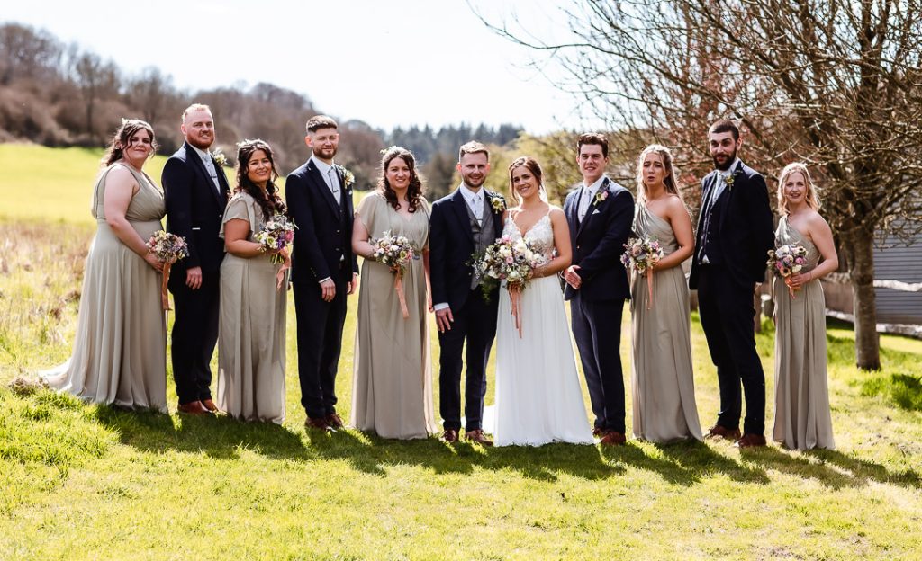 formal wedding party photo in the field