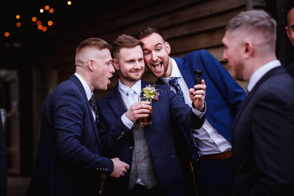 candid and fun wedding photo of groom and his friends/groomates