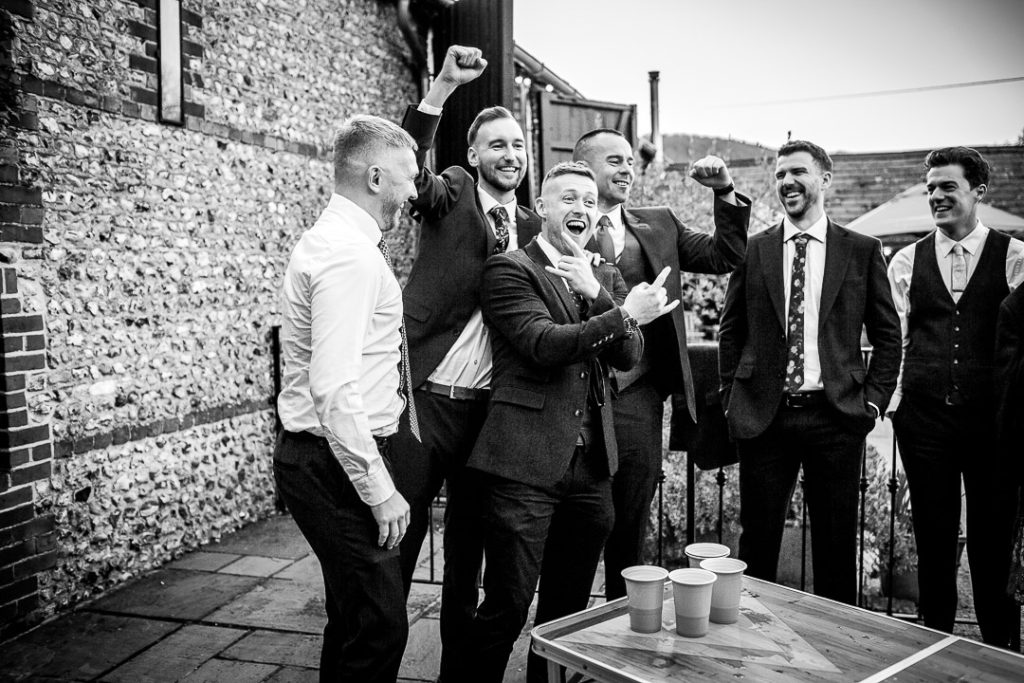 black and white fun and candid wedding photo of Groom with his groomates