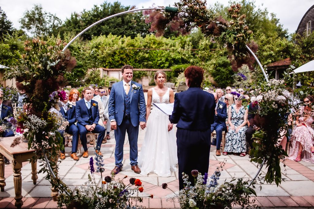 outdoor summer wedding ceremony at Oxleaze Barn, Lechlade