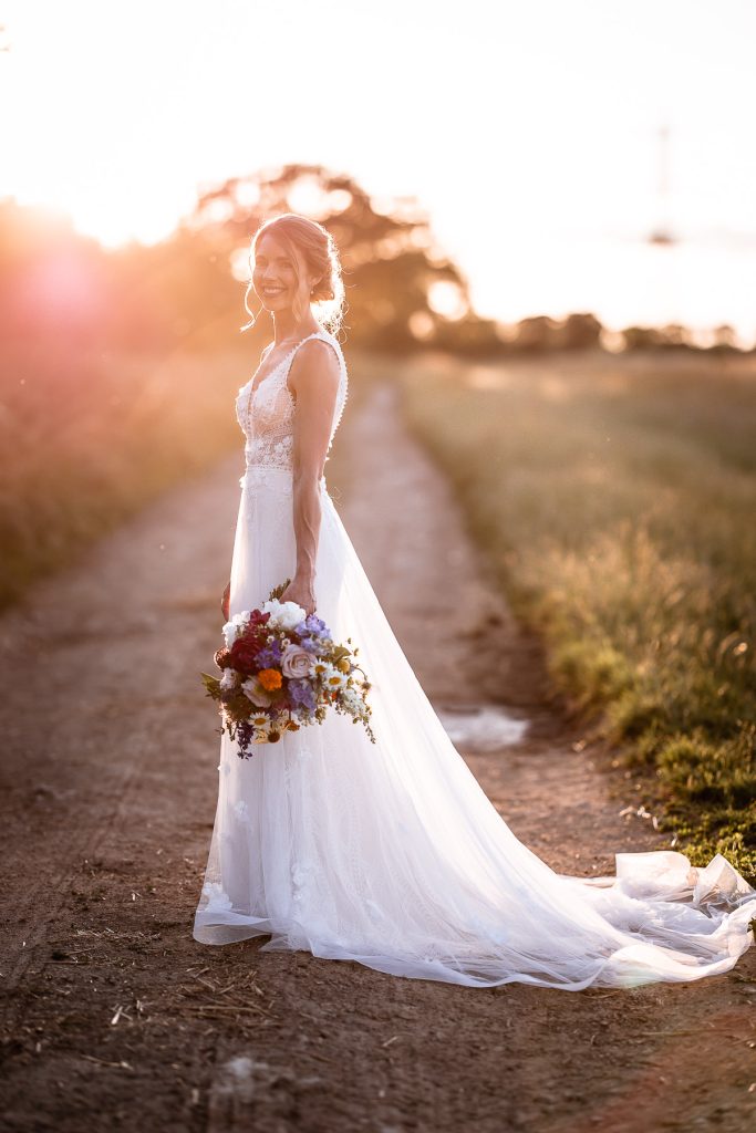 Sunset photo of bride holding her flowers