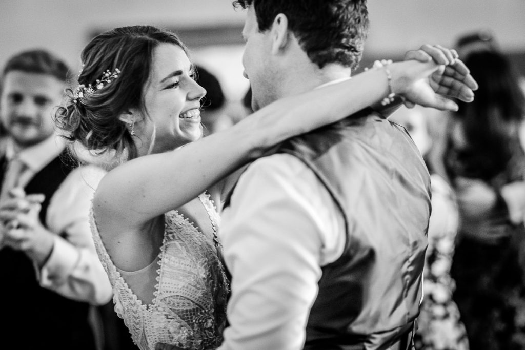 black and white photo of bride and groom dancing togheter