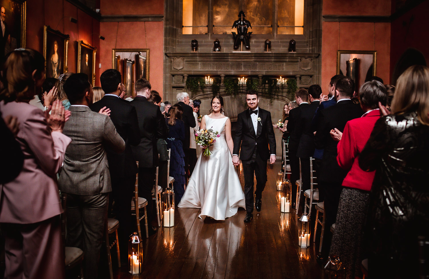 Groom and bride got married and leaving the ceremony room at Cowdray House in Midhurst