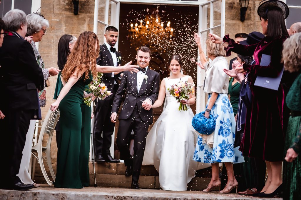 Confetti photo of bride and groom at Cowdray House in Midhurst