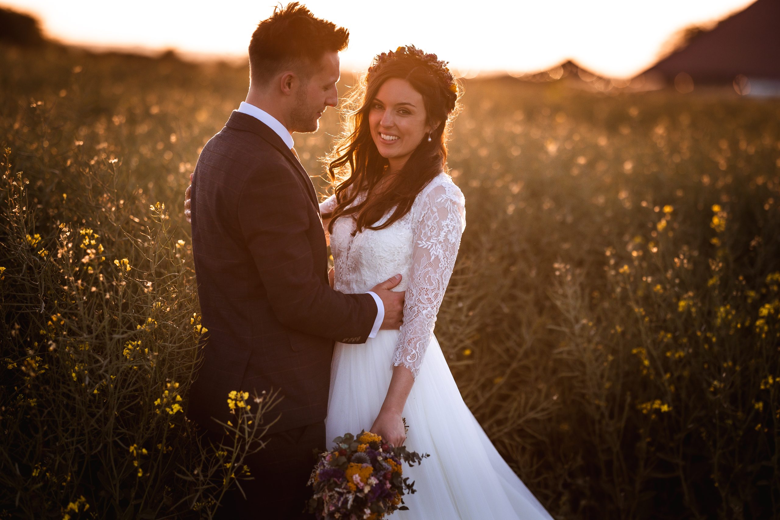 sunset photos of wedding couple in the field in West Sussex. Golden Hour wedding photo