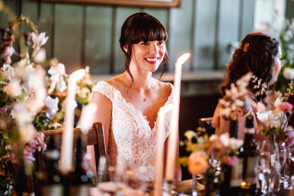 Natural photo of smiling bride by the candles