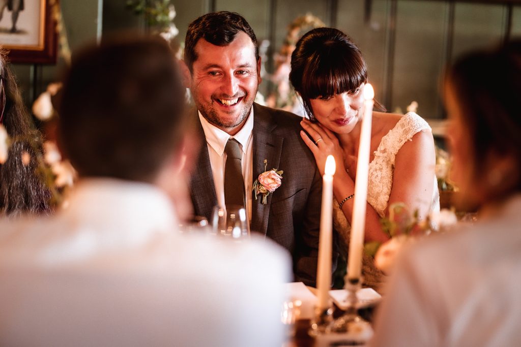 Natural and candid photo of weedding couple during the dinner at Alton The Anchor Inn at Lower Froyle