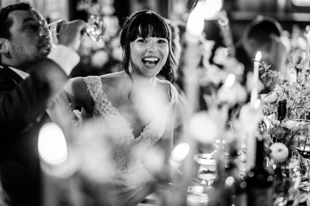 Candid photo of bride laughing during the speech