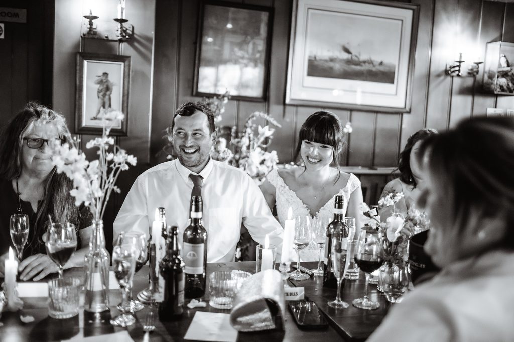 Candid photos of wedding couples laughing during the speech