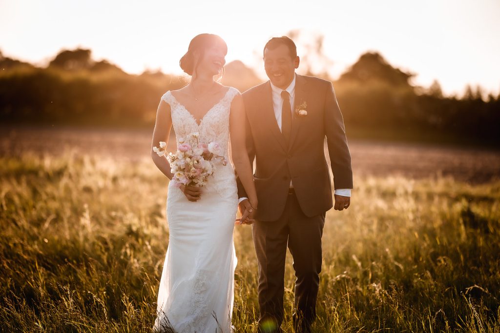 Sunset photos of bride and groom. Wedding couple during the golden hour