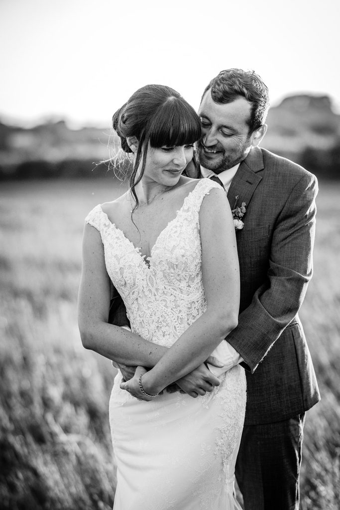 black and white photo of bride and groom. Wedding couple during the golden hour