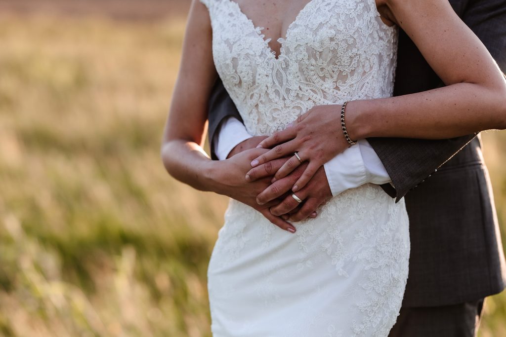 Wedding rings creatively photographed. Wedding couple during the golden hour