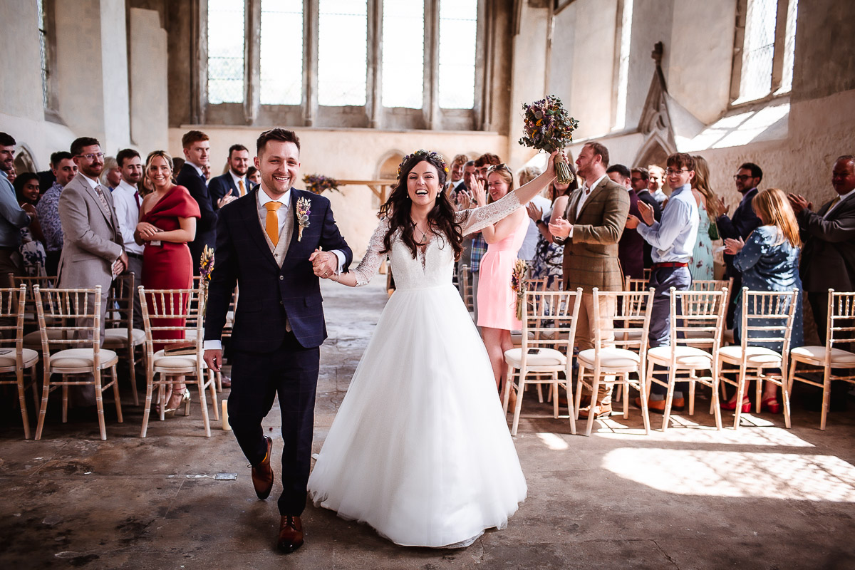 bride and groom leaving a church after their ceremony