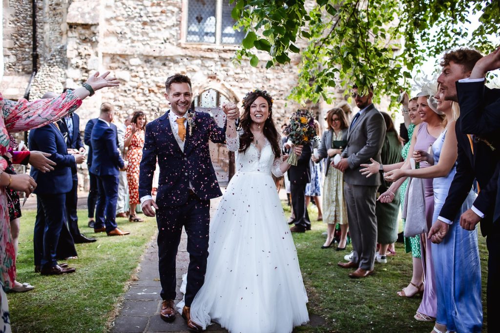 colourful confetti photo of bride and groom by the church Guildhall, Chichester wedding photographer