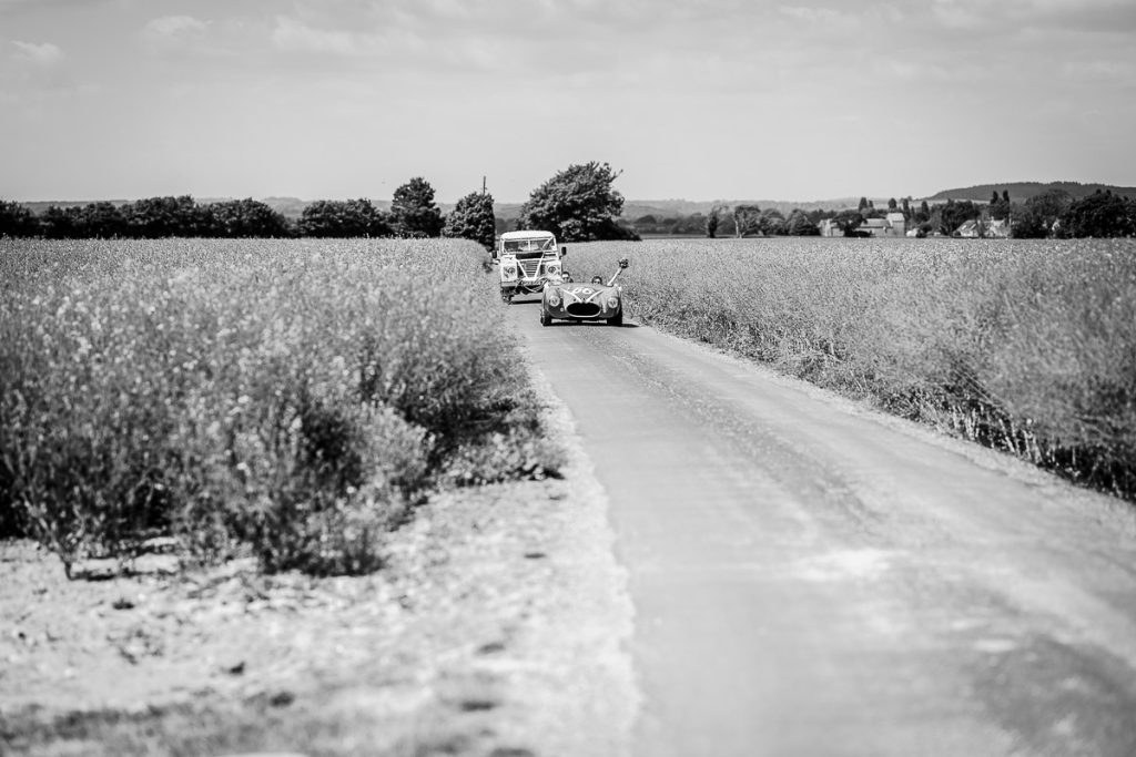 bride and groom are coming in the wedding car. West Sussex wedding photographer