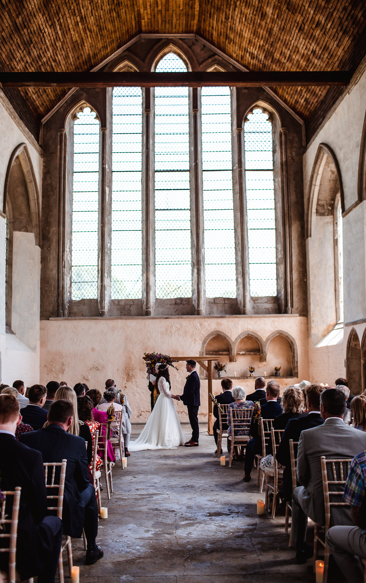 bride and groom holding hands during the wedding ceremony in the church Guildhall, Chichester, West Sussex wedding photographer