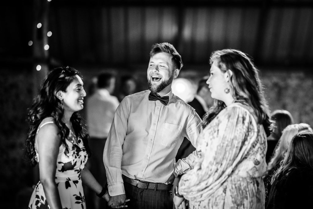 natural photos of wedding guests laughing and having fun during the speeches. West Sussex wedding photography