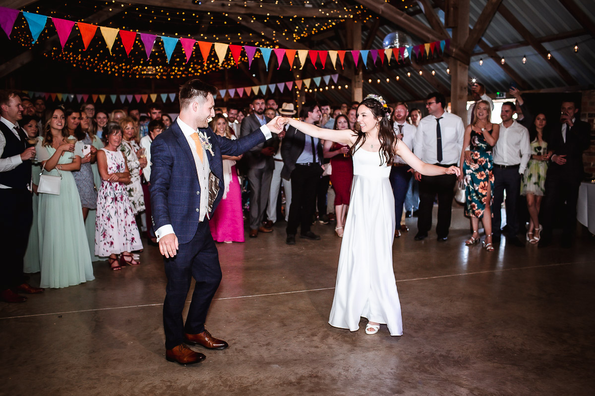 groom and bride's first dance in a wedding barn