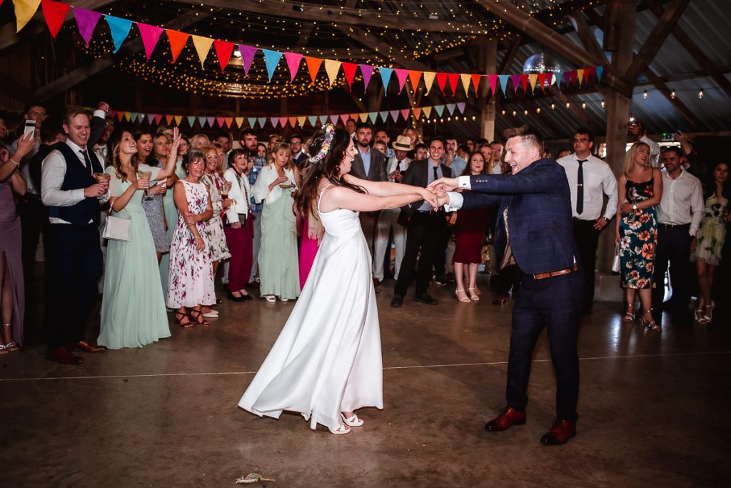 groom and bride's first dance in a wedding barn