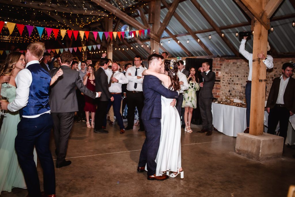 groom and bride's first dance in a wedding barn