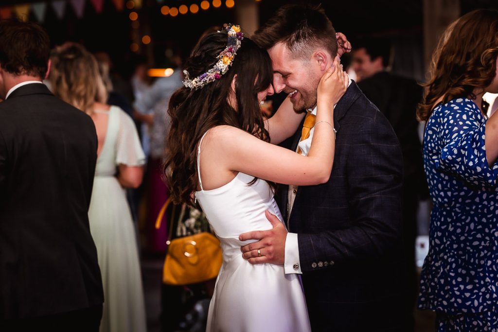 groom and bride's first dance in a wedding barn