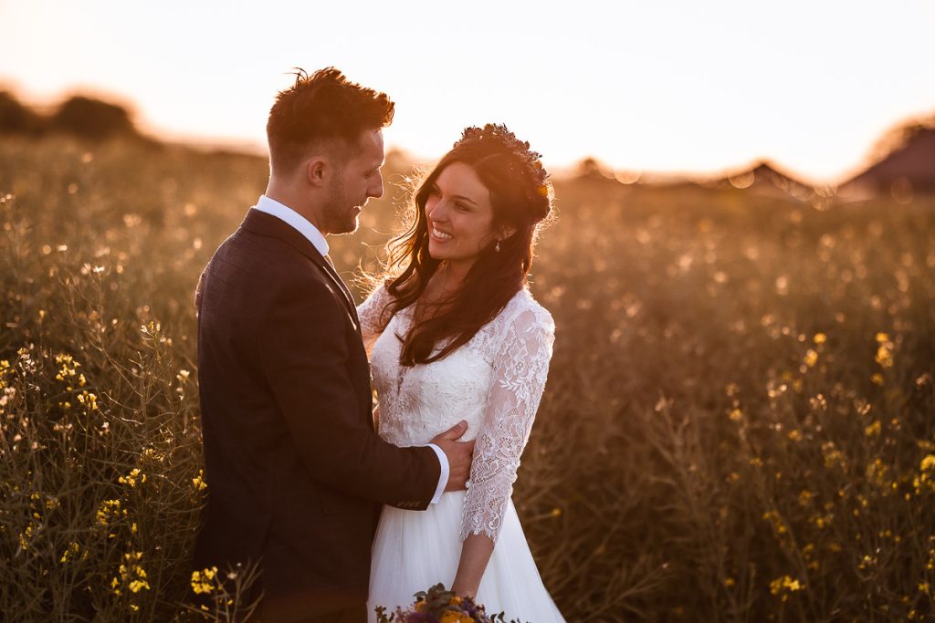 magical sunset photos of bride and groom in the field at Chidham Barn