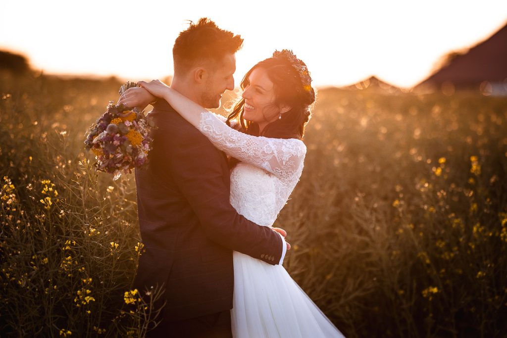 magical sunset photos of bride and groom in the field at Chidham Barn wedding photography