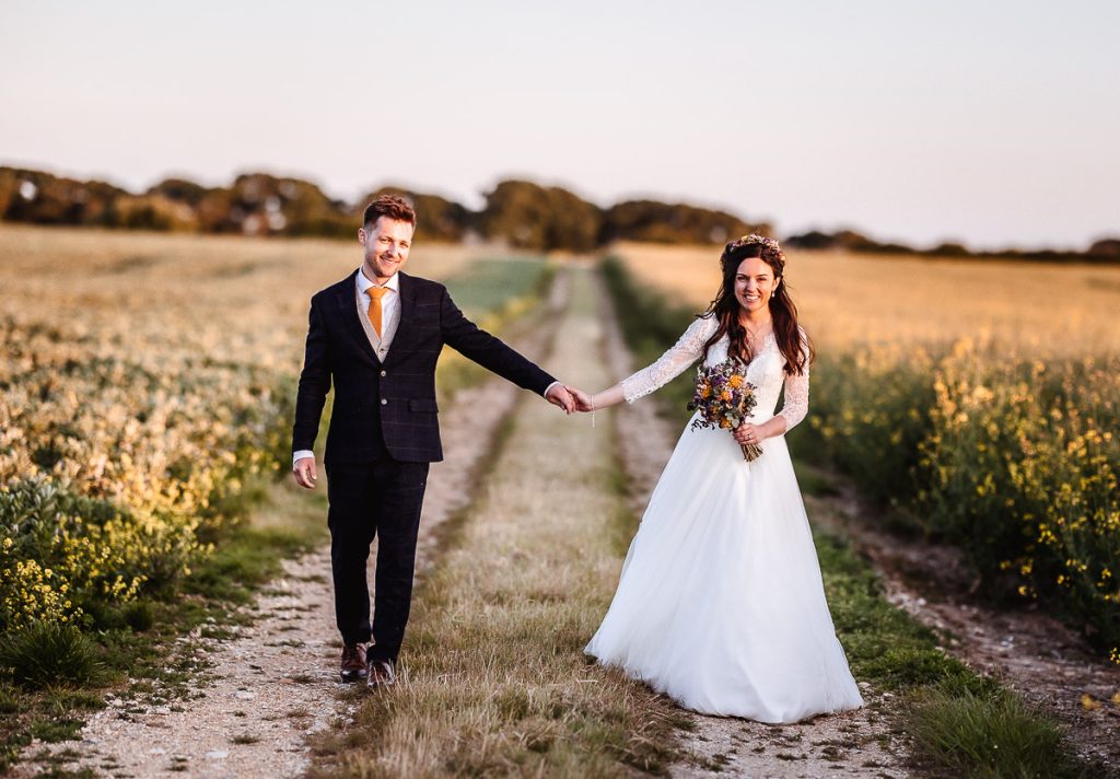 magical sunset photos of bride and groom in the field. Romantic west sussex wedding photographer