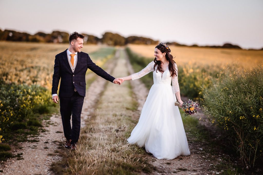 magical sunset photos of bride and groom in the field in the countryside 