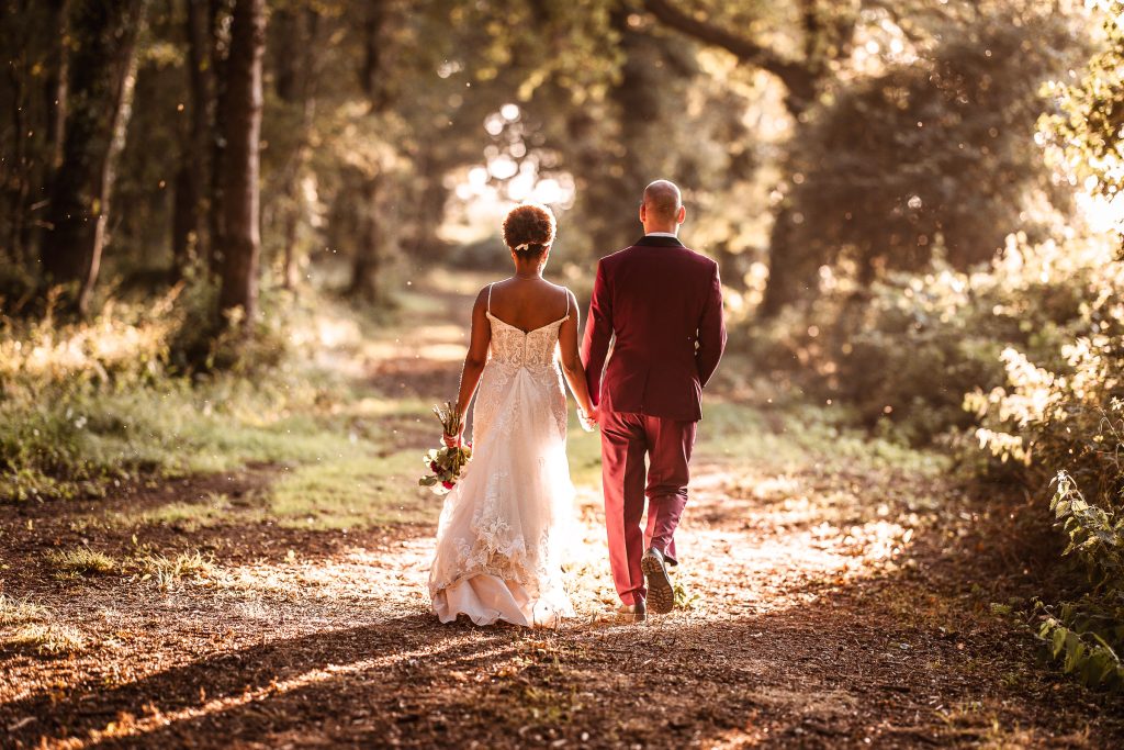 sunset photo of bride and groom walking in the forest at Hayling Island Tournerbury Woods Estate Hampshire