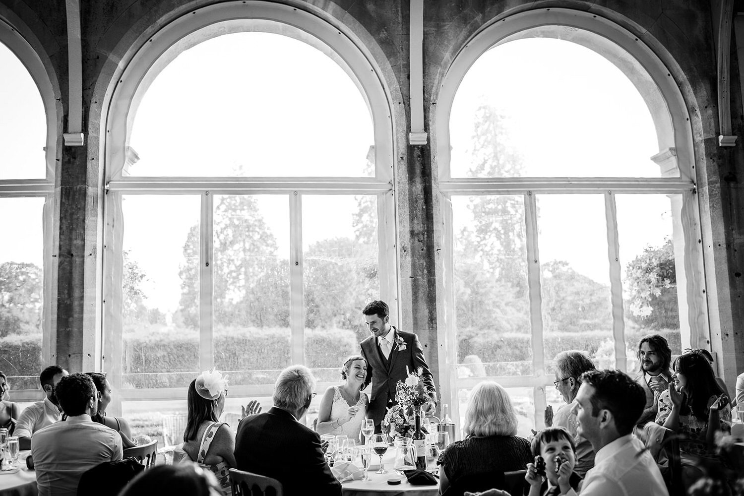 black and white photo of bride and groom during the speech at Grittleton House, Wiltshire