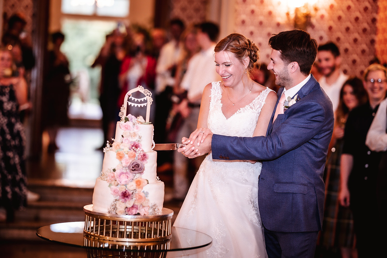 bride and groom are cutting a cake at Grittleton House