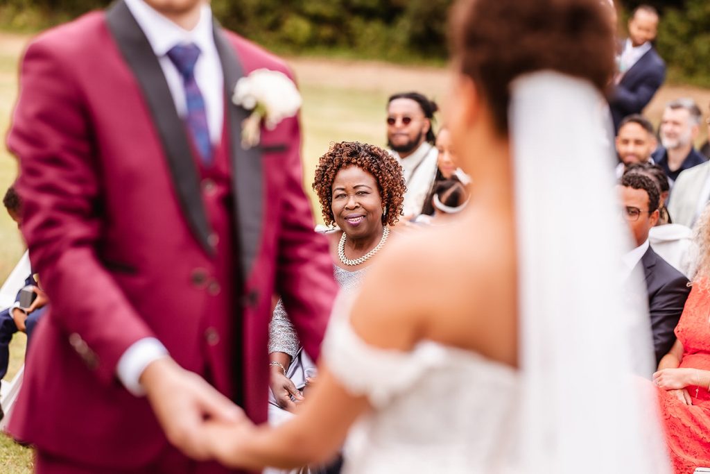 bride's mum watching her daughter getting married during the outdoor wedding ceremony in Hayling island.