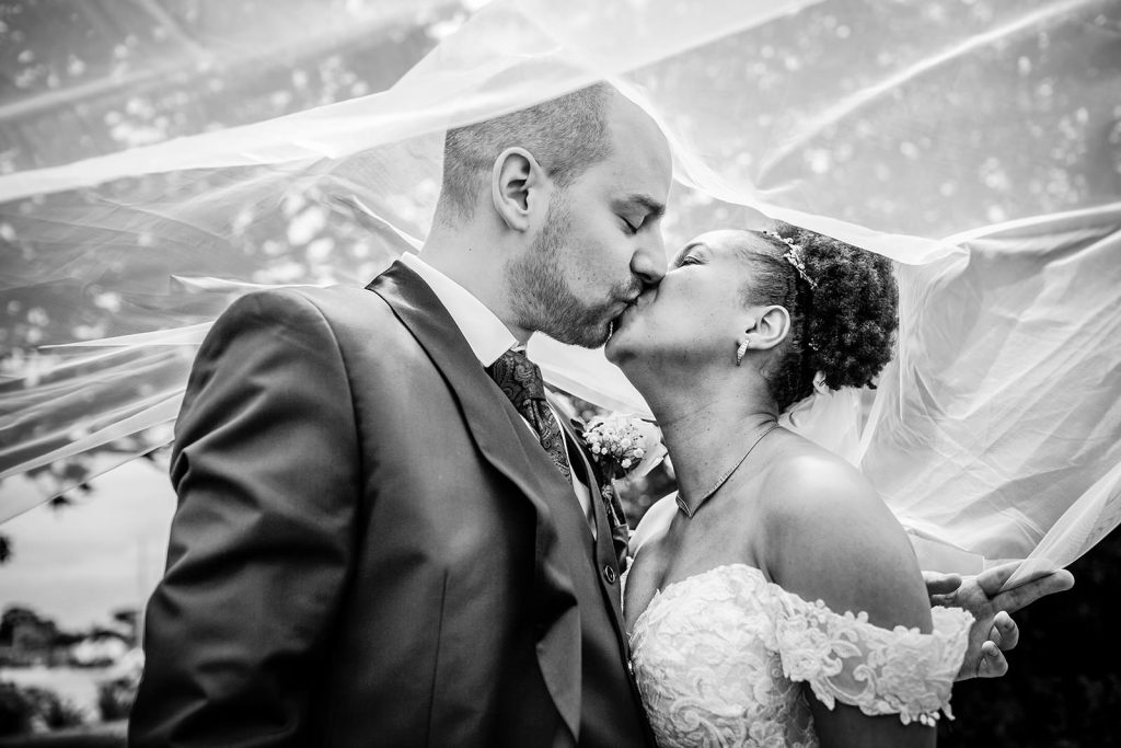 bride and groom kissing under the wedding veil. Hampshire romantic wedding photography