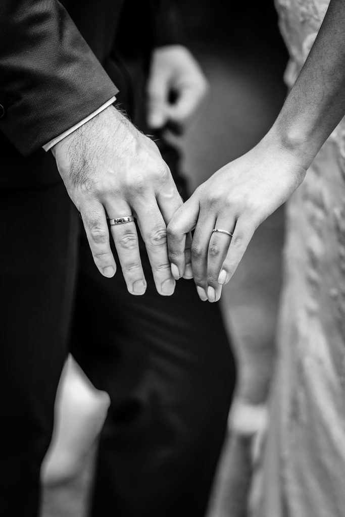 wedding photo with details of hands with wedding rings. Hampshire wedding photography