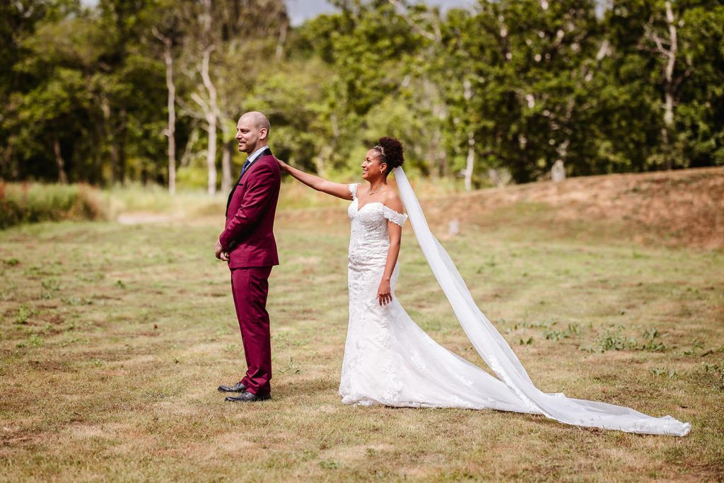 Bride and groom first look in the field at Tournerbury Woods Estate.