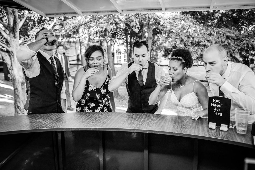 bride and groom having their shots at the venue at Tournerbury Woods