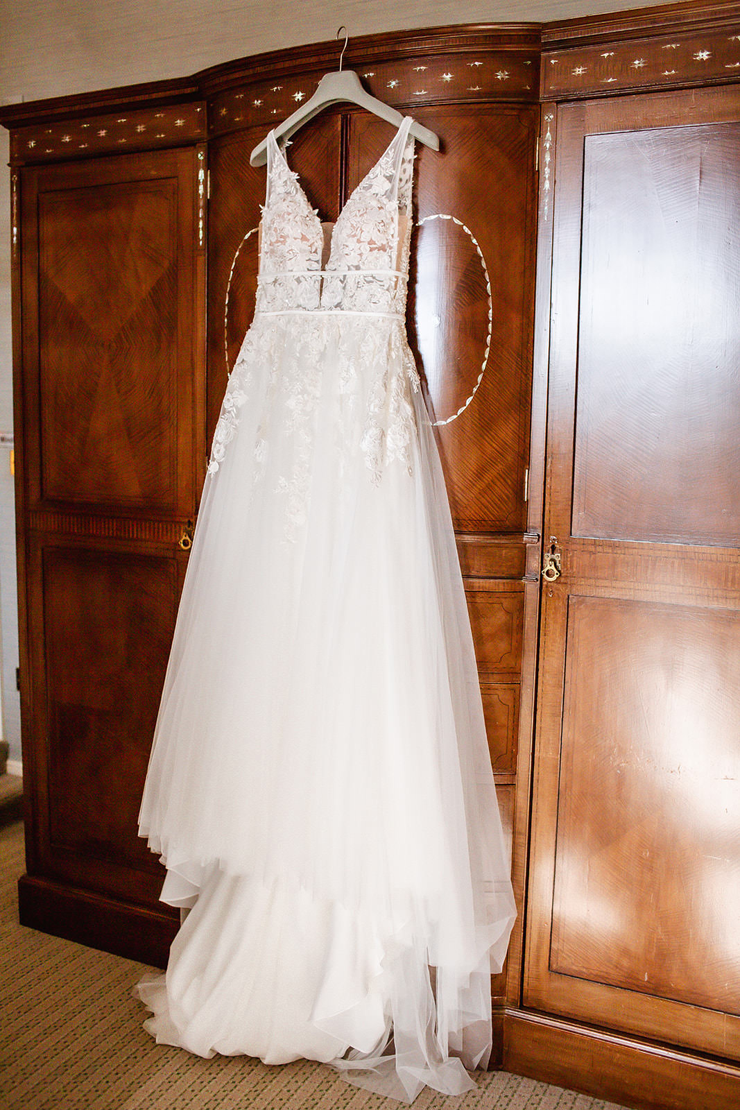 wedding dress hanged on the wooden cupboard at Winchester Royal Hotel