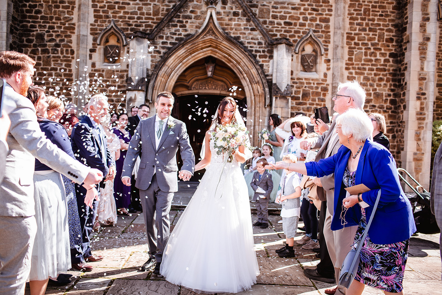 confetti photo of bride and groom outside of the church in Chichester