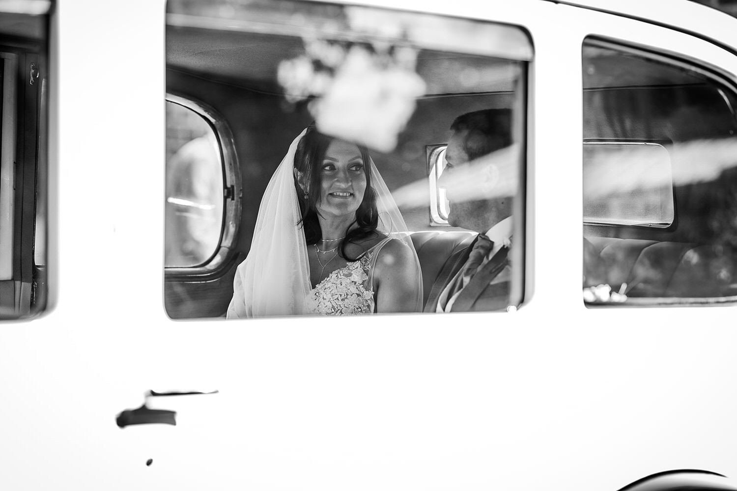 black and white photo of bride and groom sitting in the car in Winchester wedding