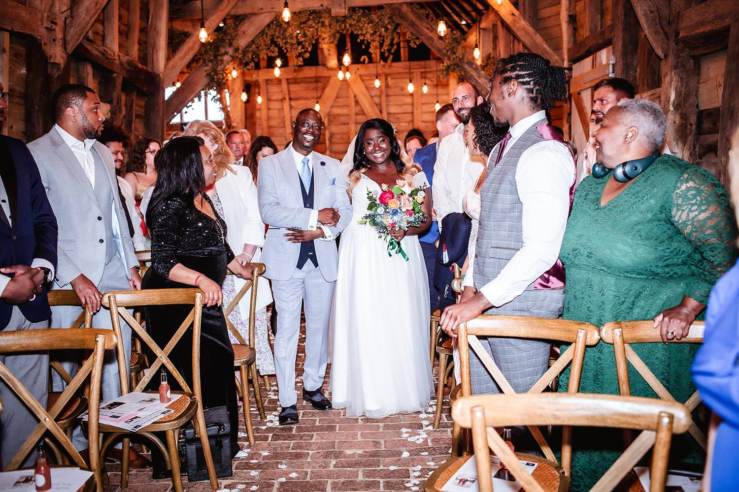 bride and her dad coming down the isle at High Billinghurst Farm, Surrey wedding photographer