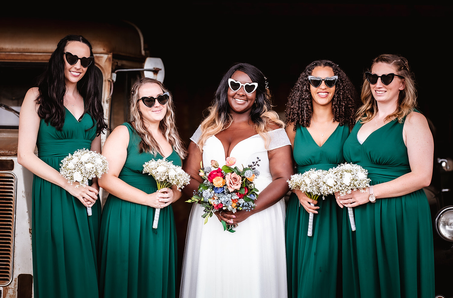 bride and her bridesmaid with the heart shape glasses on holding their flowers High Billinghurst Farm