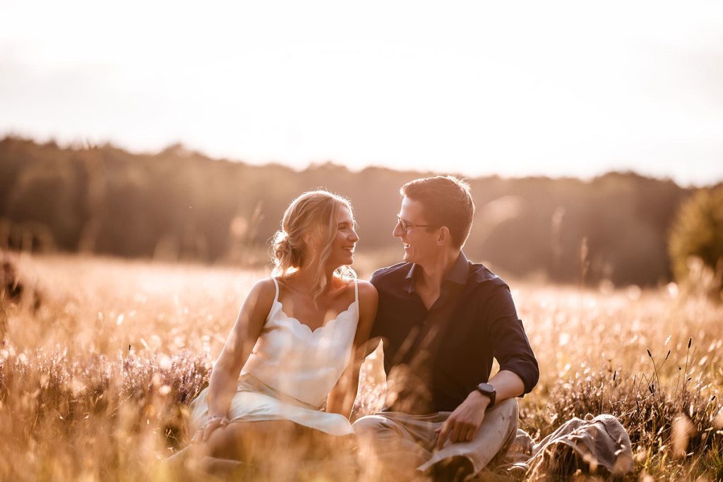 Hampshire natural pre wedding photographer. Engagement photo session in the field during the sunset