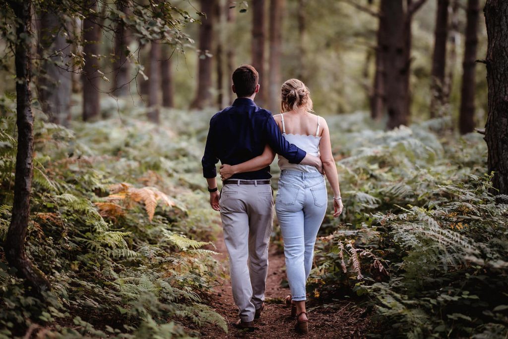 Natural engagement photo session in Hampshire. couple walking together in the forest in Petersfield