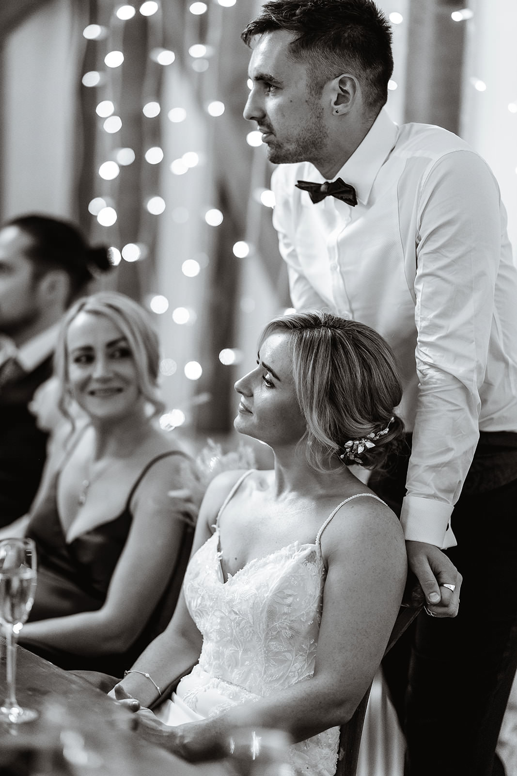 groom standing behind the bride during the speech. Candid photo of wedding couple at Gate Street